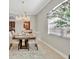 Elegant dining room featuring a crystal chandelier, seating for six, and natural light at 5531 Arnie Loop, Bradenton, FL 34211
