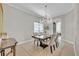 Bright dining room with a chandelier, stylish chairs, and an arched doorway at 5531 Arnie Loop, Bradenton, FL 34211