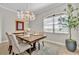 Charming dining room featuring a chandelier, seating for six, and a faux olive tree at 5531 Arnie Loop, Bradenton, FL 34211