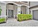 Charming home entrance featuring a decorative front door, address plaque, and lush greenery at 5531 Arnie Loop, Bradenton, FL 34211