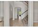 Spacious foyer with staircase, arched doorways, and neutral tile flooring at 5531 Arnie Loop, Bradenton, FL 34211
