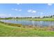 A scenic golf course with a serene pond offers a tranquil escape with lush landscaping at 5531 Arnie Loop, Bradenton, FL 34211