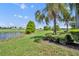 A pristine golf course and scenic pond offer stunning views from the lush green landscape at 5531 Arnie Loop, Bradenton, FL 34211