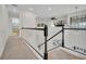 Hallway with decorative railing and chandelier, leading to additional rooms at 5531 Arnie Loop, Bradenton, FL 34211