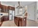 Kitchen island features a gas cooktop, stainless steel refrigerator, and storage at 5531 Arnie Loop, Bradenton, FL 34211