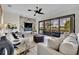 Modern living room offers lots of light, marble accent wall with fireplace, and view of the golf course at 5531 Arnie Loop, Bradenton, FL 34211