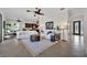 Open concept living room with tile floors, white sofas, and view of the dining area and front door at 5531 Arnie Loop, Bradenton, FL 34211