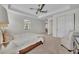 Large bedroom with a ceiling fan, an accent chair, and view of another area of the house at 5531 Arnie Loop, Bradenton, FL 34211