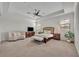 Spacious main bedroom featuring tray ceilings, neutral walls, carpet, and a decorative ceiling fan at 5531 Arnie Loop, Bradenton, FL 34211