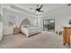 Bright bedroom with trey ceiling, ceiling fan and access to a screened in balcony at 5531 Arnie Loop, Bradenton, FL 34211