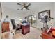 Home office with a ceiling fan and sliding glass doors leading to a screened-in patio at 5531 Arnie Loop, Bradenton, FL 34211
