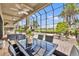 Covered and screened-in patio featuring an outdoor dining area and a gorgeous view of the pool and golf course at 5531 Arnie Loop, Bradenton, FL 34211
