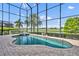 Sparkling screened-in pool with a golf course view and a brick paved patio at 5531 Arnie Loop, Bradenton, FL 34211