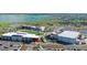 Aerial view showcases community amenities: school, sports fields, parking, and beautiful lake at 42862 Park View Dr, Punta Gorda, FL 33982