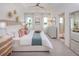 Serene main bedroom with tray ceiling, coastal decor, and views of the water at 42862 Park View Dr, Punta Gorda, FL 33982