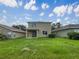 Backyard featuring a grassy lawn and a covered patio, with the home's exterior in view at 10429 Avelar Ridge Dr, Riverview, FL 33578