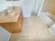 Bathroom features a double vanity, tiled floor, and bathtub at 10429 Avelar Ridge Dr, Riverview, FL 33578