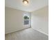 Cozy carpeted bedroom with natural light from a bright window, great for relaxing at 10429 Avelar Ridge Dr, Riverview, FL 33578
