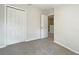 Beige carpeted bedroom with closet and doorway to the hall at 10429 Avelar Ridge Dr, Riverview, FL 33578
