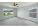Inviting bedroom with carpeted floors and bright windows overlooking the neighborhood at 10429 Avelar Ridge Dr, Riverview, FL 33578