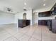 Modern kitchen open to the living area, featuring dark cabinetry and stainless appliances at 10429 Avelar Ridge Dr, Riverview, FL 33578
