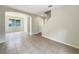 Spacious living room with tile flooring, an arched entryway and staircase with natural light at 10429 Avelar Ridge Dr, Riverview, FL 33578