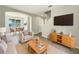 Bright living room showcasing modern furnishings, tiled floors, and a dining area with natural light at 10429 Avelar Ridge Dr, Riverview, FL 33578