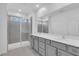 Modern bathroom featuring a double vanity, large mirror, and a tiled walk-in shower at 17322 Alderwood Ln, Punta Gorda, FL 33982