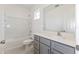 Bathroom showcasing a shower-tub, modern vanity with quartz countertop and gray cabinets at 17322 Alderwood Ln, Punta Gorda, FL 33982