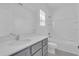 Bathroom featuring shower over bath, vanity unit, and large mirror at 17322 Alderwood Ln, Punta Gorda, FL 33982