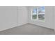 Bright bedroom with a large window offering a serene view of the outdoors at 17322 Alderwood Ln, Punta Gorda, FL 33982