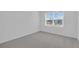 Bright bedroom with plush carpet and window allowing natural light at 17322 Alderwood Ln, Punta Gorda, FL 33982