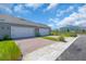 Modern home featuring two garage doors, a brick driveway and manicured landscaping at 17322 Alderwood Ln, Punta Gorda, FL 33982