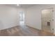 Hallway with neutral carpet leads to a bright room and a laundry area; natural light at 17322 Alderwood Ln, Punta Gorda, FL 33982