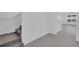 Hallway with stairs to upper level and adjacent doorway to bedroom at 17322 Alderwood Ln, Punta Gorda, FL 33982