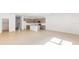 Open-concept living space with neutral tile flooring and modern kitchen with stainless appliances at 17322 Alderwood Ln, Punta Gorda, FL 33982