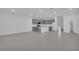 Open-concept living space with tile flooring and gray kitchen cabinets at 17322 Alderwood Ln, Punta Gorda, FL 33982