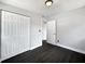 Bedroom features dark hardwood floors, white walls, closet and bright lighting at 5001 S 88Th St, Tampa, FL 33619