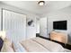 Cozy bedroom featuring a neutral palette, large closet, and modern dresser beneath a mounted television at 5001 S 88Th St, Tampa, FL 33619