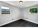 Bedroom features hardwood floors, white walls and two windows at 5001 S 88Th St, Tampa, FL 33619