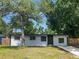 Charming one-story home featuring a freshly painted exterior, mature shade trees, and a new concrete driveway at 5001 S 88Th St, Tampa, FL 33619