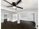 Open-concept living space featuring dark wood floors, exposed beams, and fresh paint at 5001 S 88Th St, Tampa, FL 33619