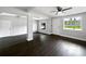Open-concept living space featuring dark wood floors, exposed beams, and great natural light at 5001 S 88Th St, Tampa, FL 33619