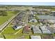 A high-angle view shows a well-planned community with lush landscaping and houses with backyard swimming pools at 8297 Ivy Stark Blvd, Wesley Chapel, FL 33545