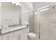 Bathroom features a large shower with glass door and white vanity with granite countertop at 8297 Ivy Stark Blvd, Wesley Chapel, FL 33545