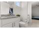 Modern bathroom featuring granite countertops, white cabinets, and an adjacent bedroom view at 8297 Ivy Stark Blvd, Wesley Chapel, FL 33545
