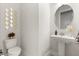 Half bathroom with a pedestal sink and modern mirror accents at 8297 Ivy Stark Blvd, Wesley Chapel, FL 33545