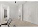 Bedroom with carpet, doors, and a connecting bathroom, creating a private and functional space at 8297 Ivy Stark Blvd, Wesley Chapel, FL 33545