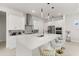 Well-lit modern kitchen features an island with quartz countertops and stainless steel appliances at 8297 Ivy Stark Blvd, Wesley Chapel, FL 33545