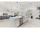 Modern kitchen with stainless steel appliances, a kitchen island, and open floor plan dining and living areas at 8297 Ivy Stark Blvd, Wesley Chapel, FL 33545